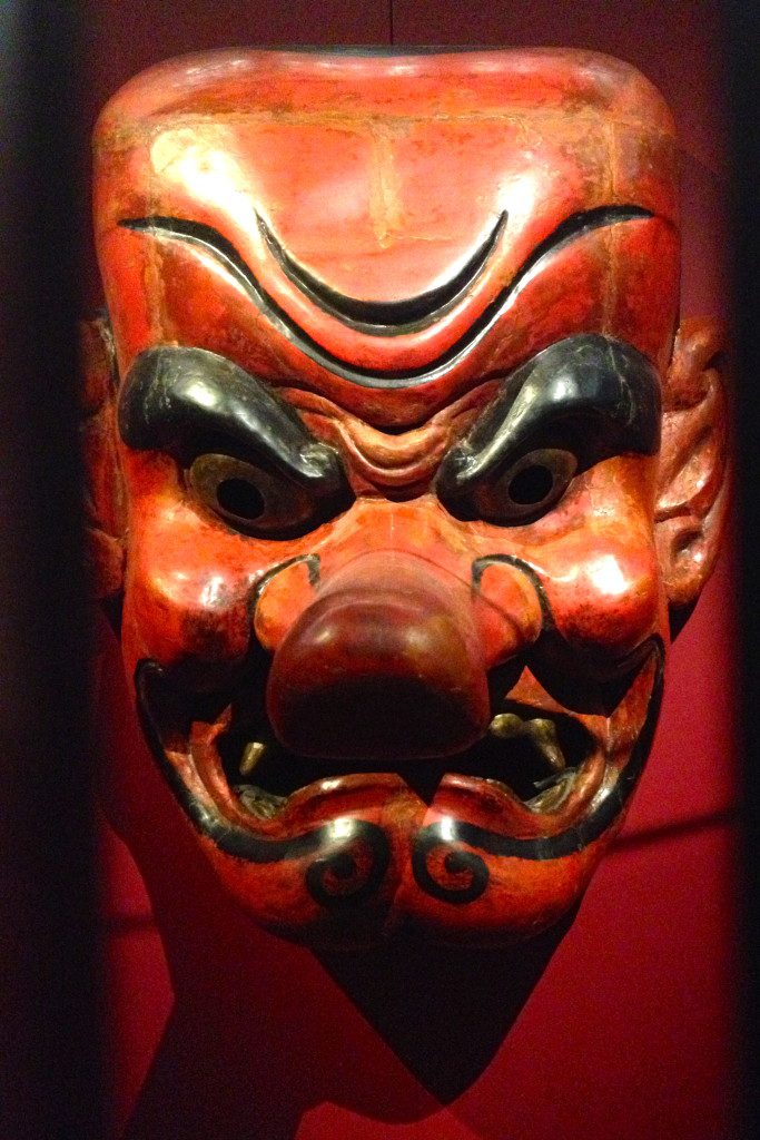 Wereldmuseum Rotterdam: World of Manga Exhibit, a red ancient Japanese mask is displayed in one of the displays